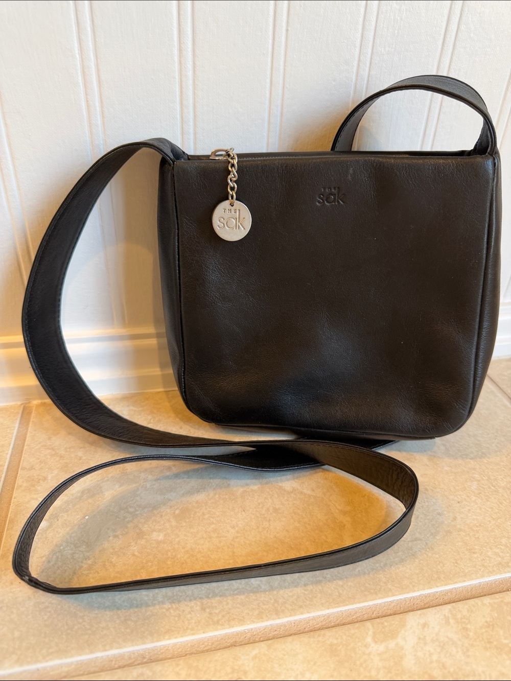 The Sak Black Leather Crossbody with Silver Charm